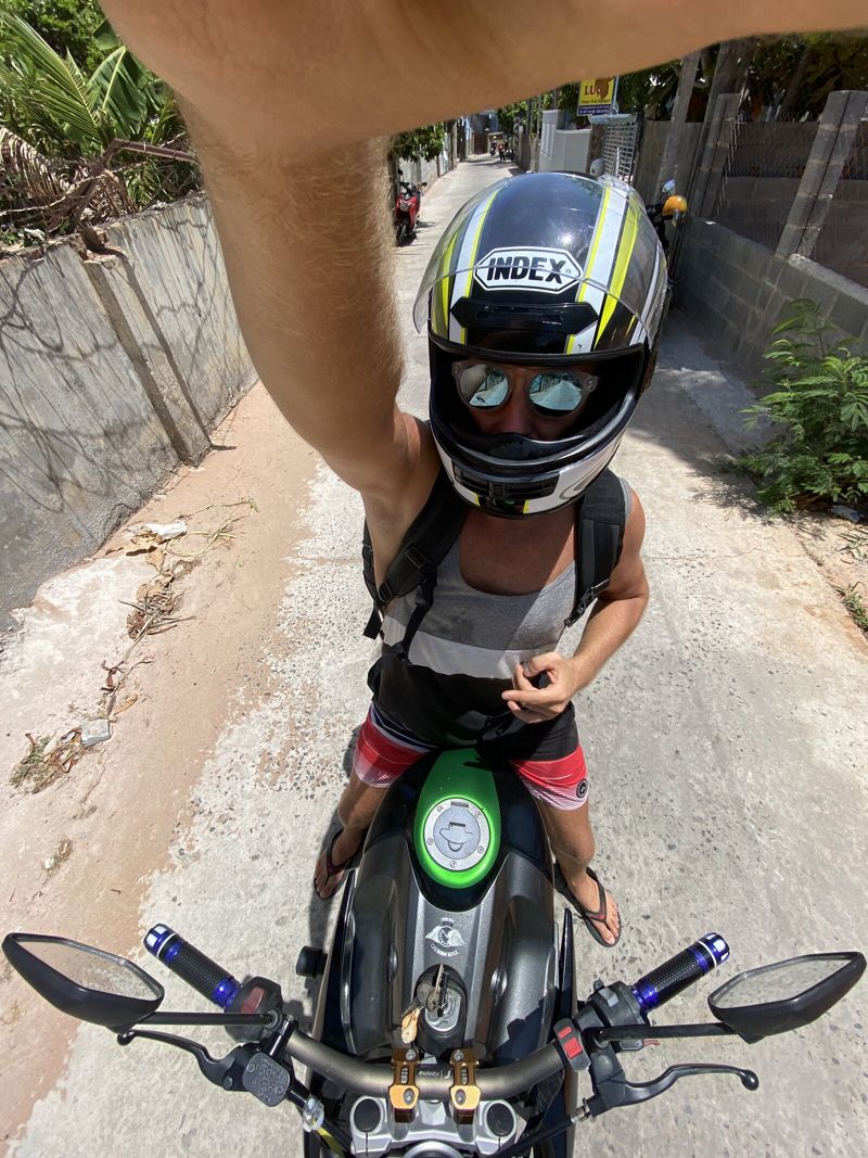 Nikita taking a selfie with motorcycle helmet on
